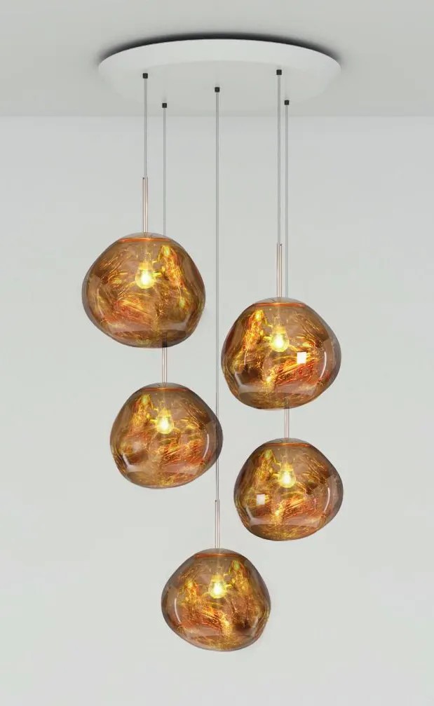 Five pendant lights from the Melt Trio Round Pendant System (Copy), each with irregular amber glass shades, hang from a white ceiling mount against a plain background.