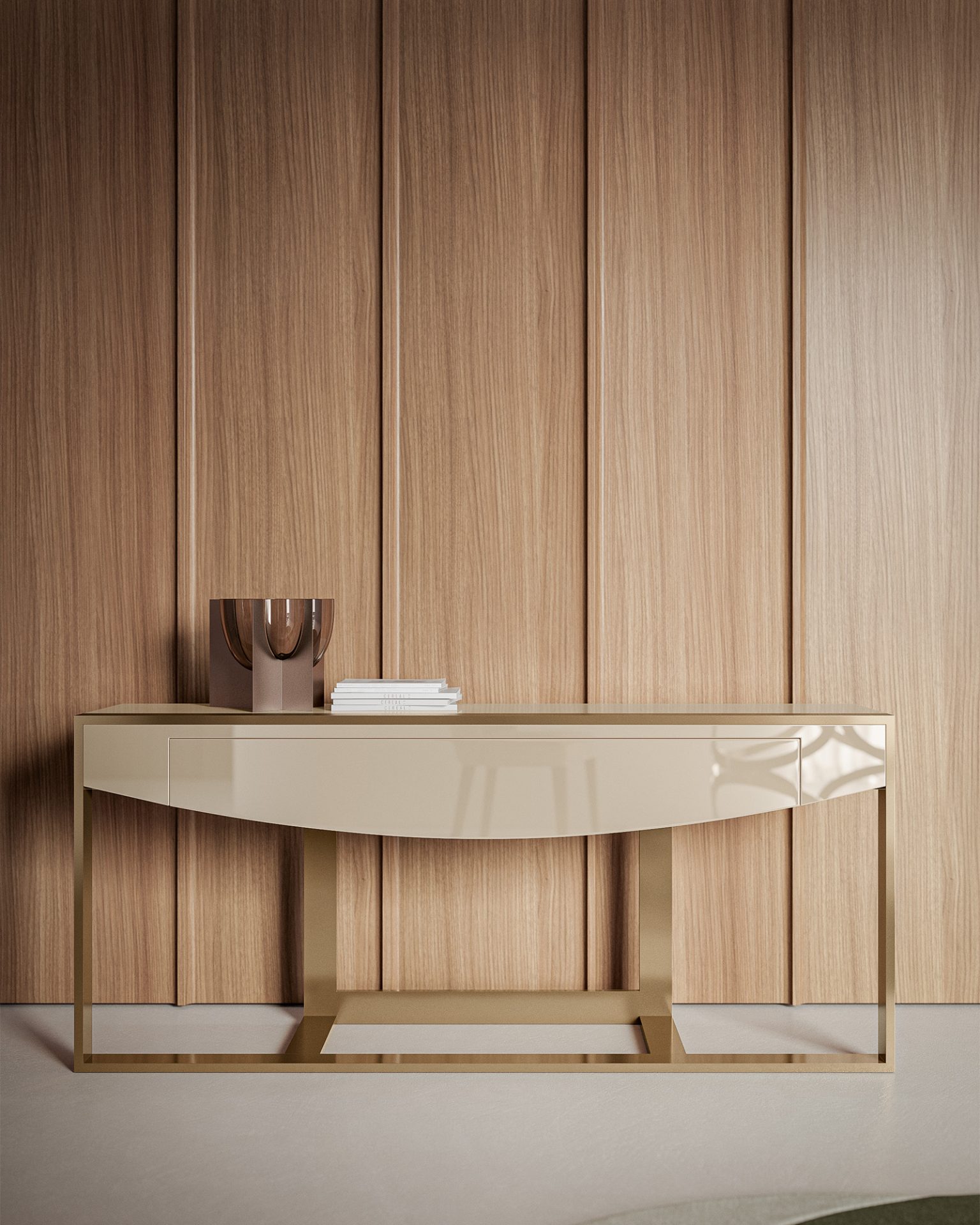 The Moon Console, a beige table with gold legs, stands against a wood-paneled wall, displaying a metallic vase and a small stack of books.